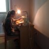 Ukrainian refugee child sewing